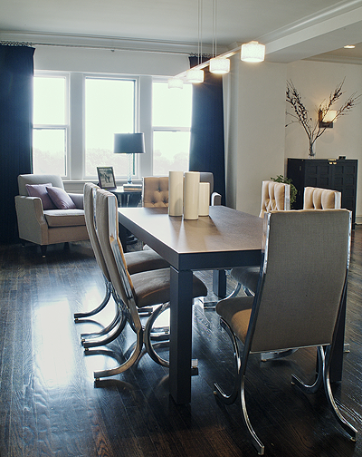 Dining room with vintage chrome chairs and blue velvet drapery