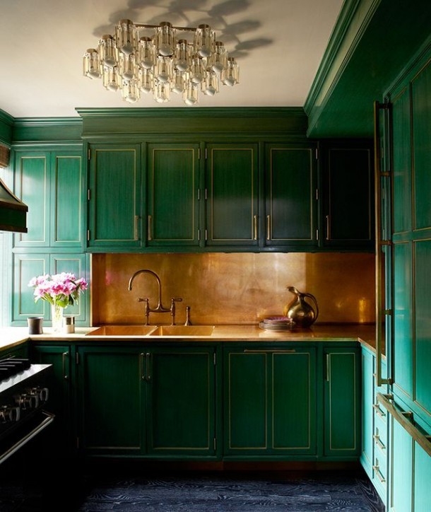 green painted kitchen with brass backsplash