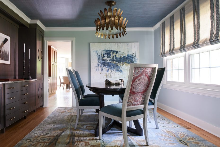 dining room with built in shelving, gold lamp from arteriors, large artwork, striped shade