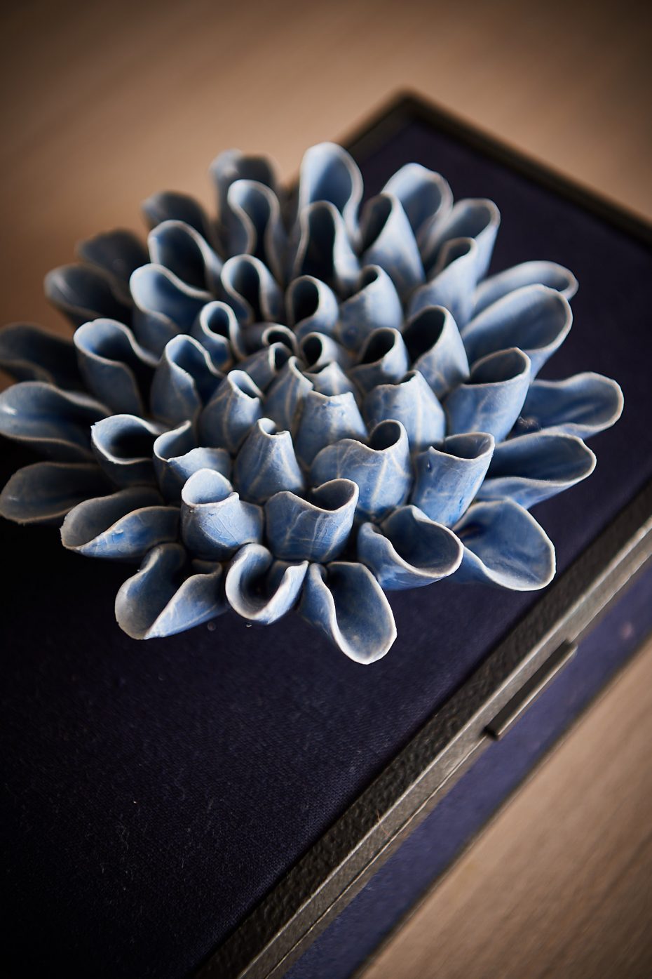 Blue ceramic flower on a blue box