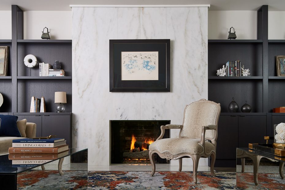 fireplace with book matched imperial danby stone, dark brown bookshelves
