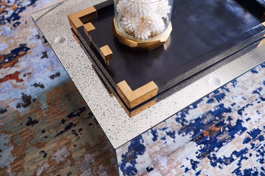 mirrored glass coffee table with a dark tray