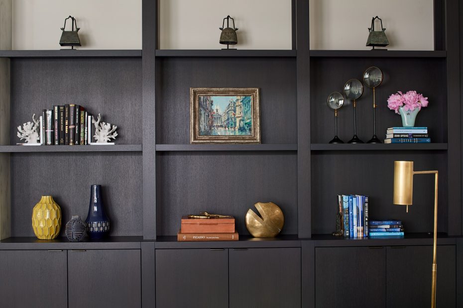dark mahogany stained bookshelves with objects