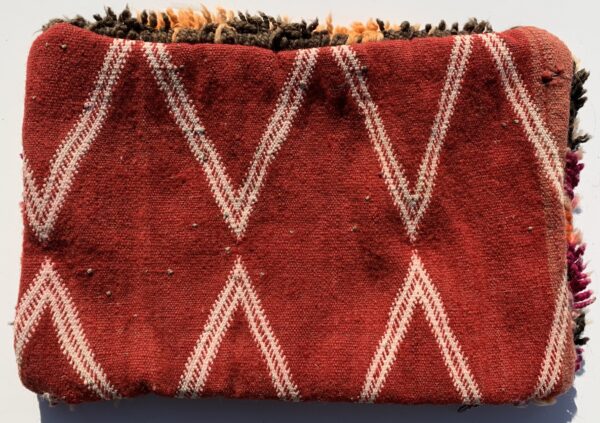 One of a kind. Moroccan pillow made from antique hand woven rugs, 2 sided pillow - plush wool on one side and flat wool on the opposite. 17 “x 11.5”. SKU 143-09. $105. Insert $50