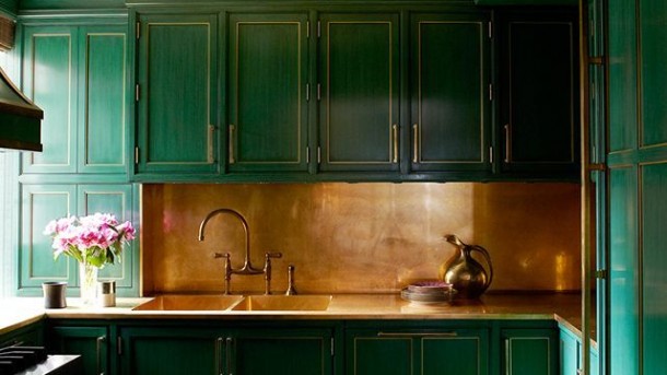 green painted kitchen with brass backsplash