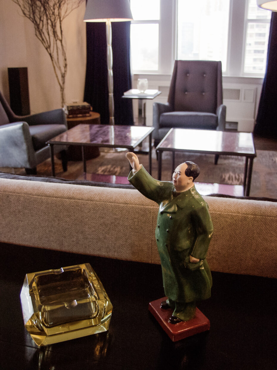 Chairman Mao sculpture; in living room with purple chairs